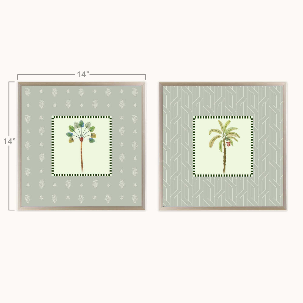 Two framed botanical art shown side by side on a light background, with dimension lines indicating 14 inches on each print. The prints feature pale sage green patterns, central cream panels, and tropical tree illustrations in muted green, brown, and small pink accents.