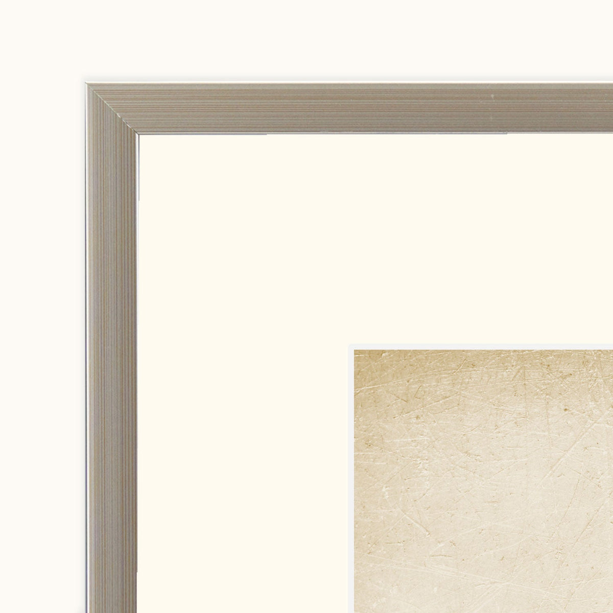 Close-up of the champagne-coloured frame and off-white mount surrounding Phoolwari floral artwork
