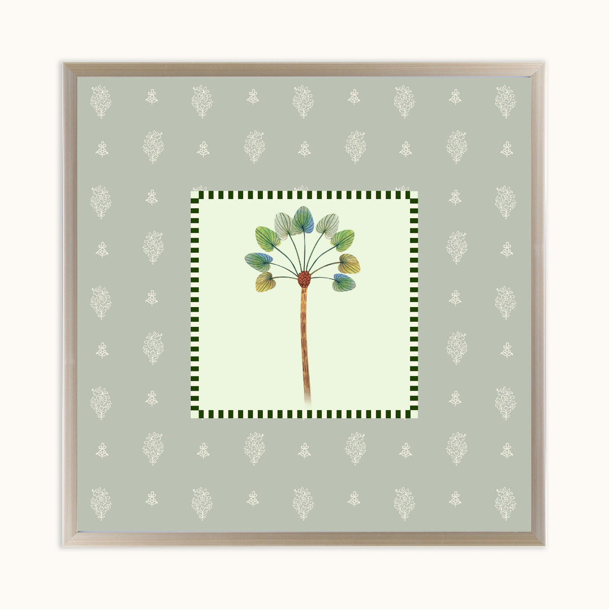 A square framed art featuring a botanical illustration of a dandelion-like plant with green and blue-green leaves on a pale yellow center panel, surrounded by a green-and-white checkered border and a sage green patterned background. The print is housed in a light wood frame and displayed against a clean off-white background.