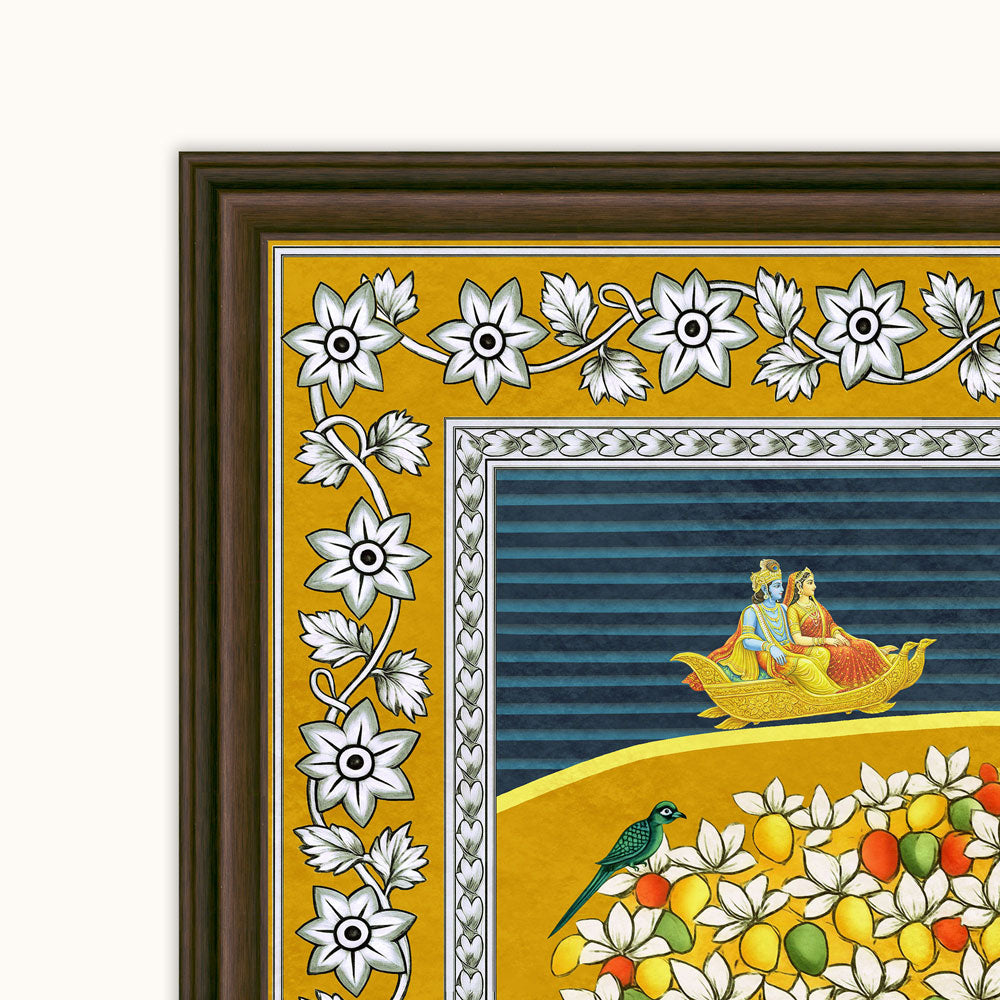 Close-up of a framed decorative art print showing a mustard-yellow border with white floral motifs, a blue striped inner panel, and a yellow lower section with flowers, fruit, and a small bird. The frame is dark brown.