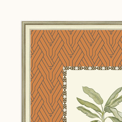 Close-up of a framed art frame showing a terracotta orange geometric patterned border, a cream background, and the top-left corner of a botanical illustration with green leaves.
