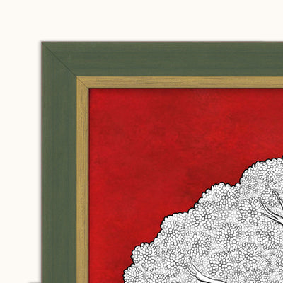 Close-up of a framed wall art showing a bold red background, a white stippled tree silhouette, and a dark green outer frame with a light wood inner trim.
