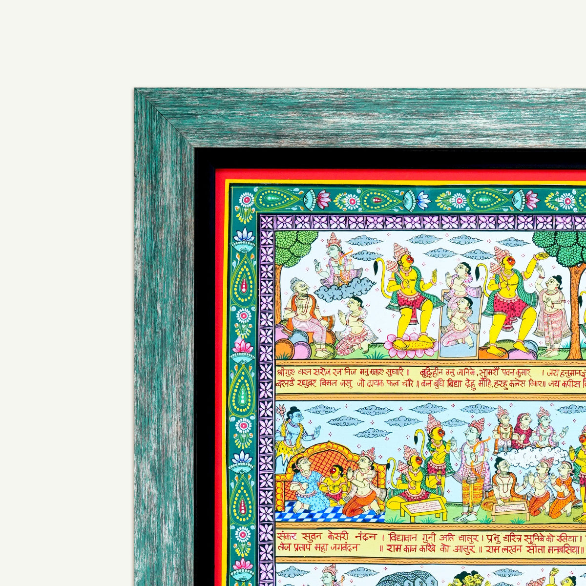 A framed traditional Indian featuring colorful mythological scenes, enclosed in a distressed teal-green wooden frame with a black mat and red inner border, shown against a light off-white background.