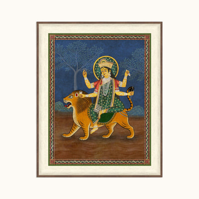 A framed Indian Madhubani style depicting a multi-armed deity riding a lion, mounted on a cream background.