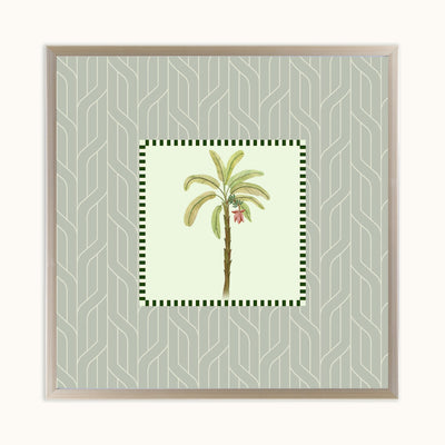 Framed square wall art featuring a central botanical illustration of a palm tree with green leaves and a small red flower, set against a pale sage green patterned background with a light wood frame.