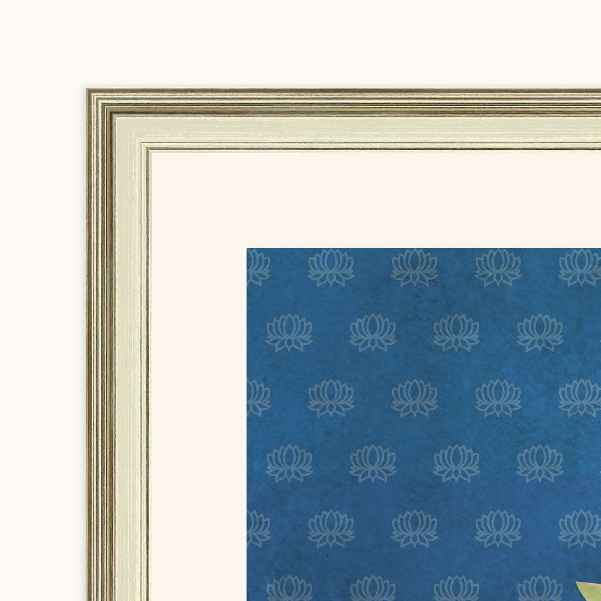 Close-up of the champagne-coloured frame and off-white border around Pichhwai Prem artwork