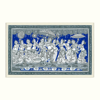 A framed traditional Indian Pichwai wall hanging depicting Lord Krishna and other deities in a blue and white hand-painted style, shown against a light cream background.