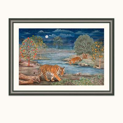 Framed art depicting a night river scene with two tigers by the water, trees with colorful foliage, and a full moon in a starry sky, shown against a light neutral background.