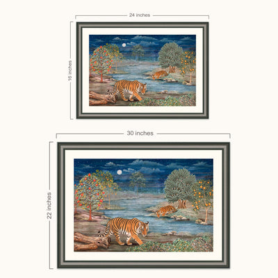 Framed tiger landscape wall art shown in two sizes with dimension labels. The artwork depicts two tigers by a river at night under a full moon, with trees and a dark blue sky.