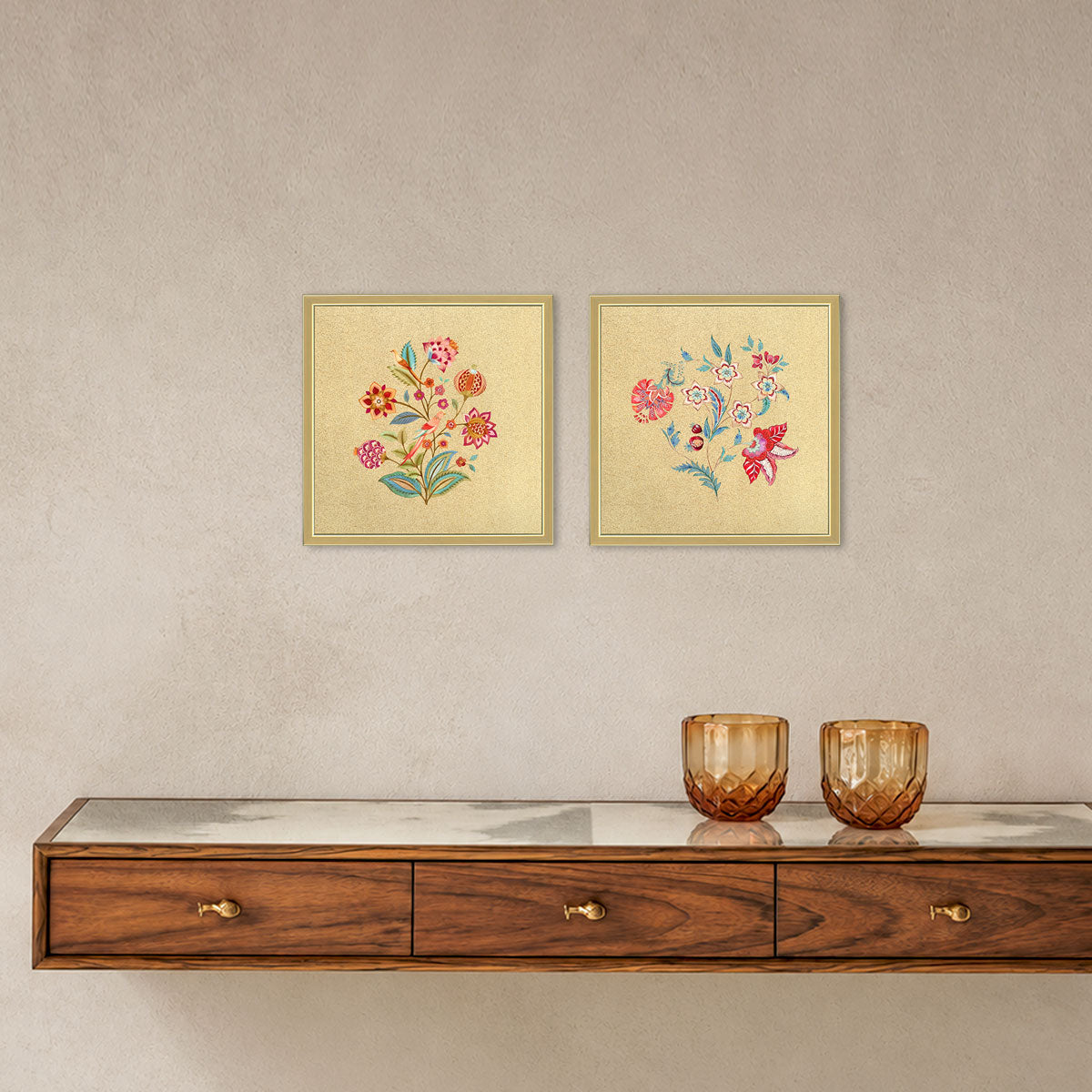 Vibrant Blossoms floral wall art set displayed above a wooden console, with two golden-framed artworks on a light wall