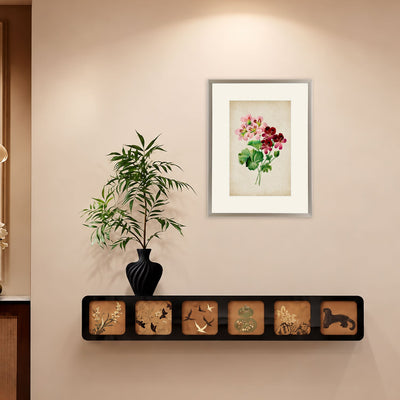 Vintage Geranium Blooms framed floral artwork displayed on a cream wall above a decorative shelf