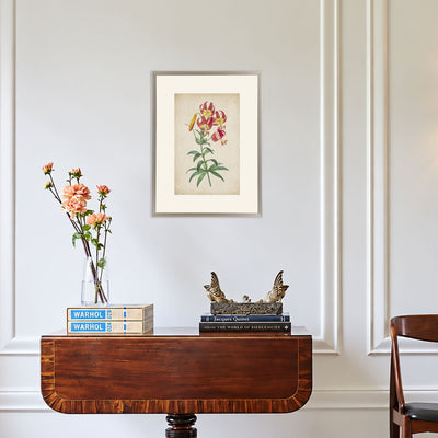 Vintage Lily pink lily wall art displayed in a champagne-coloured frame above a wooden console